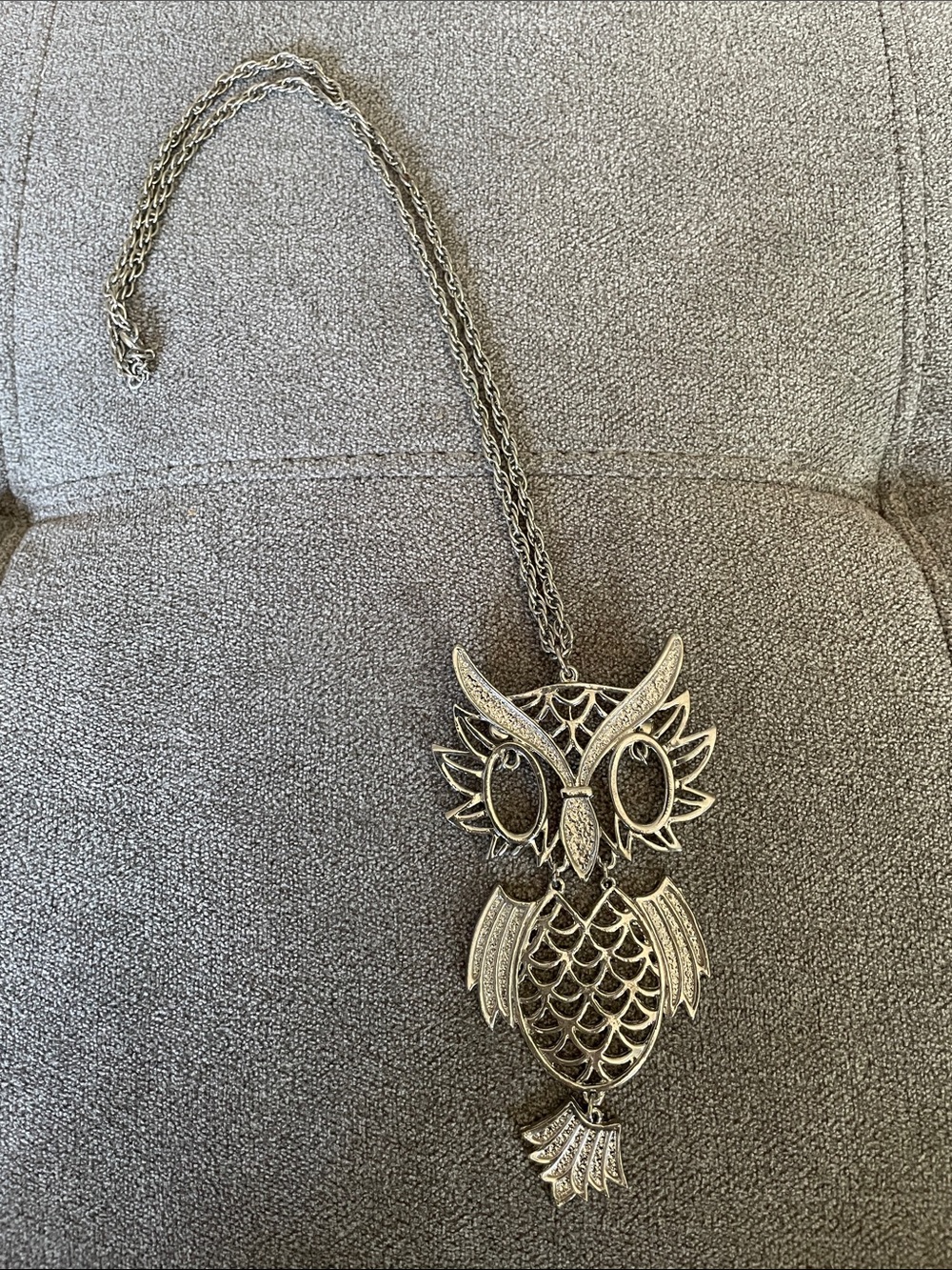 Silver necklace with chunky owl charm.
